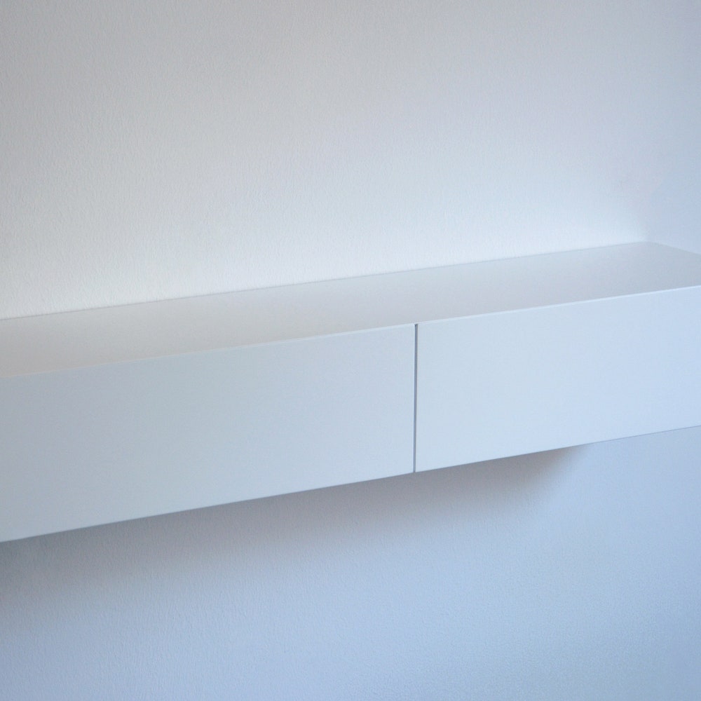 White floating entryway shelf / narrow entryway table with hidden drawers