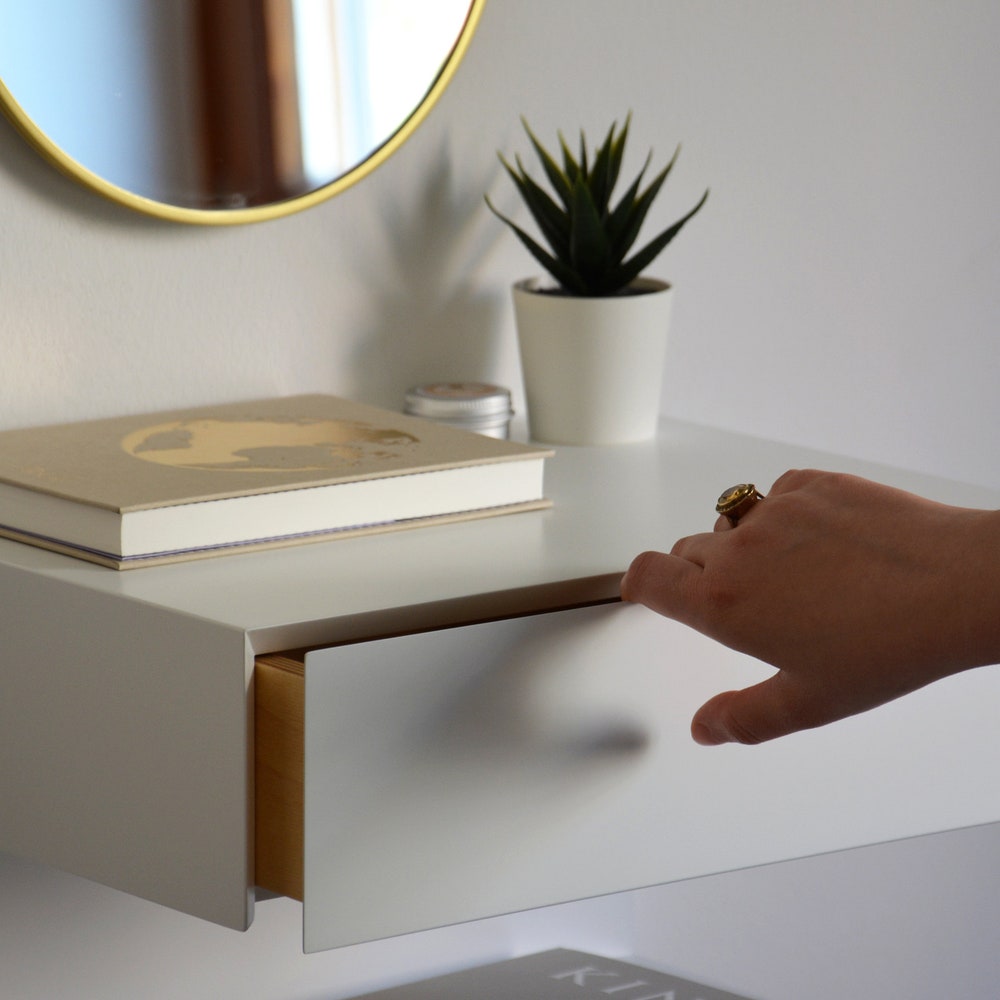 White floating nightstand with drawer and an extra shelf